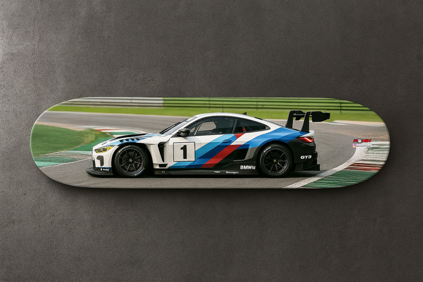 Skateboard with a BMW M4 GT4 racing car design on a gray background