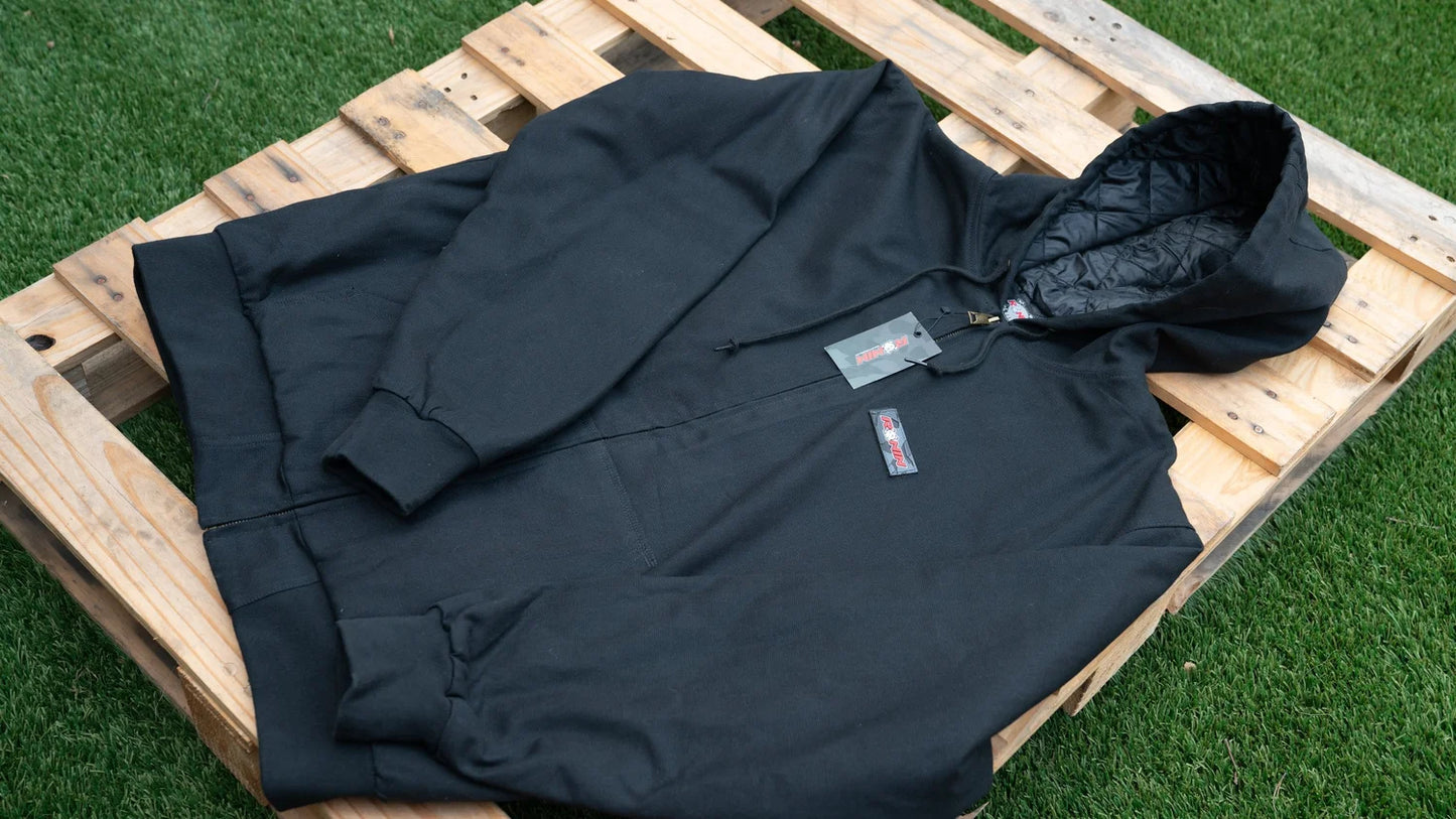 Black jacket on a wooden pallet with grass background