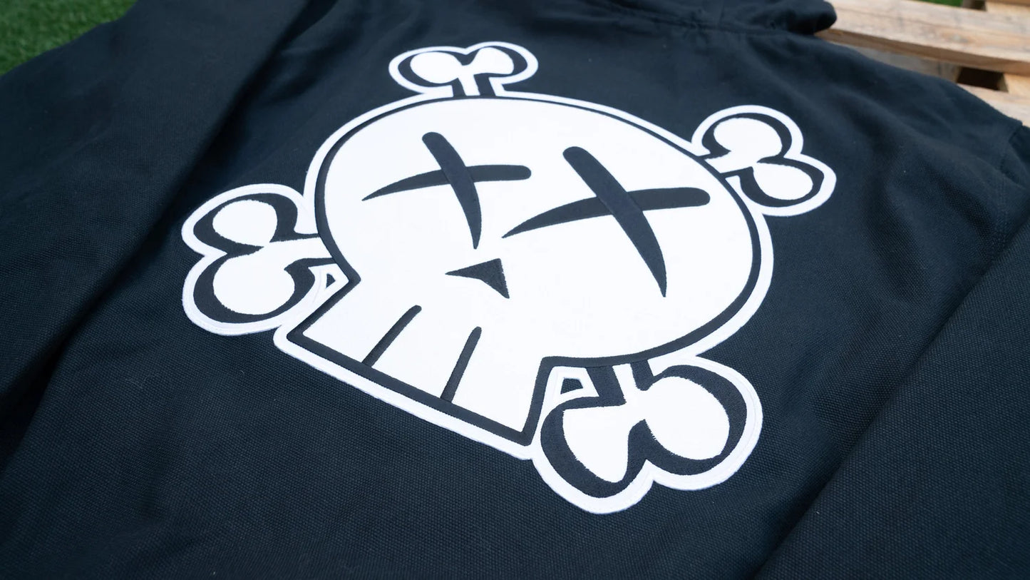 Black hooded jacket with a white graphic design on a wooden surface