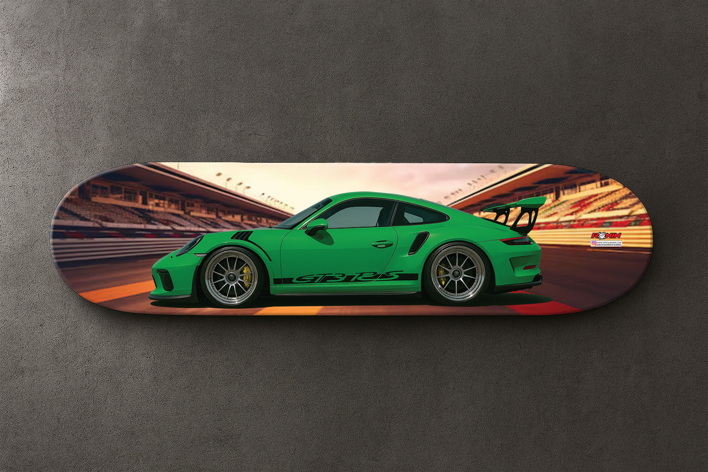 Skateboard deck with a Green Porsche GT3 RS sports car design on a gray background