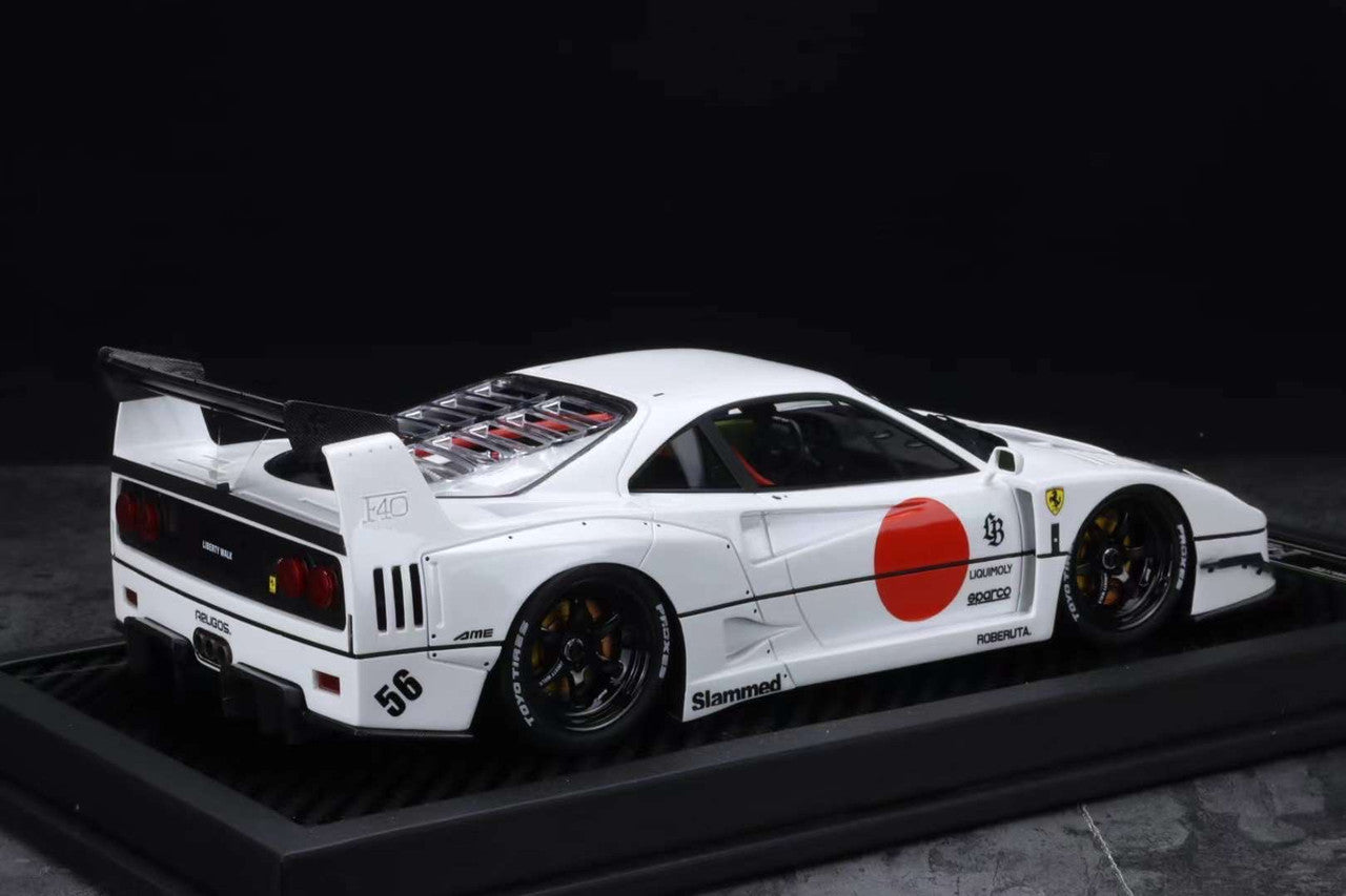 Model of a white sports car with racing decals on a dark background