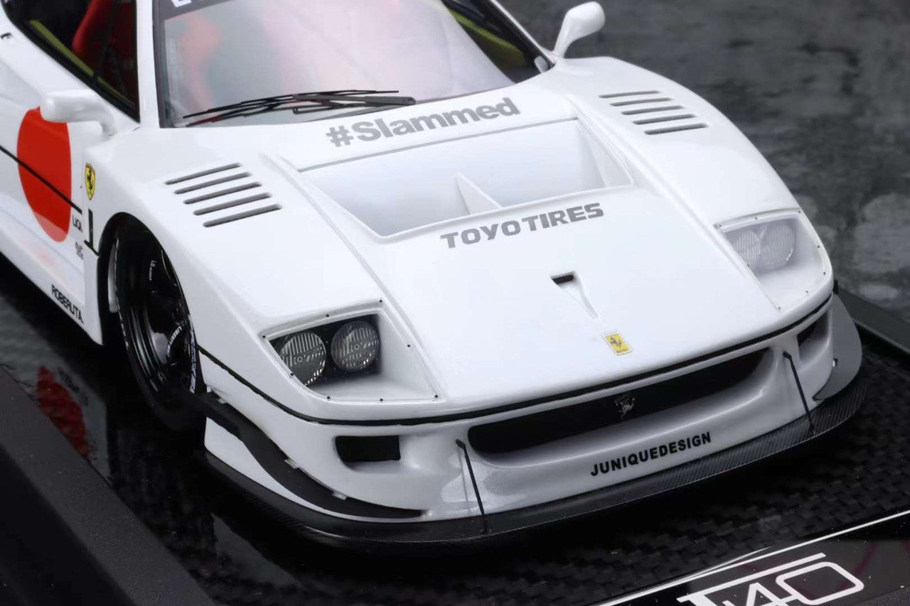 White sports car with branding on a black surface