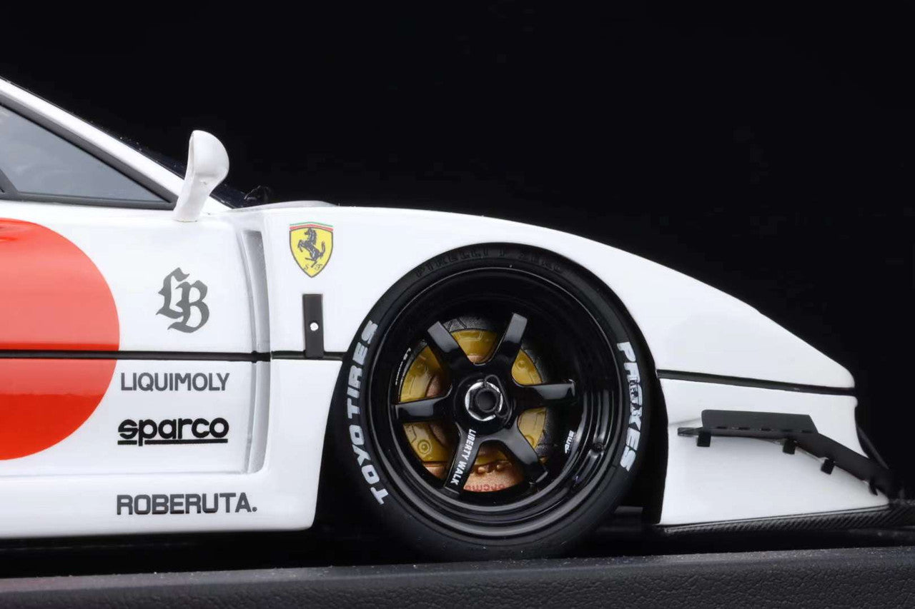Close-up of a white race car with visible branding on a black background