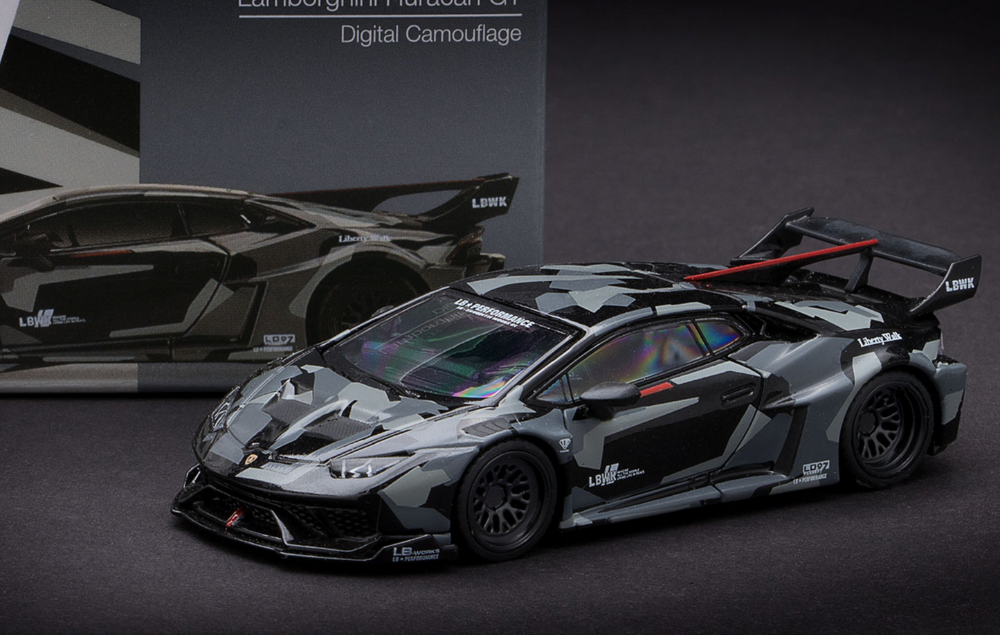 Lamborghini Huracan GT3 model car with digital camouflage design on a dark background