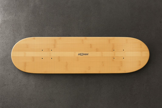 Wooden skateboard deck on a gray background