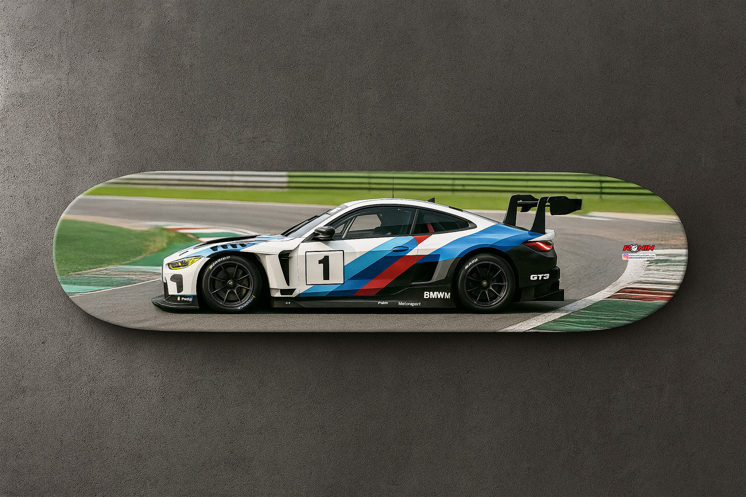 Skateboard with a BMW M4 GT4 racing car design on a gray background