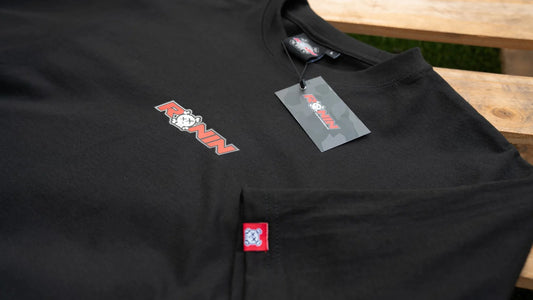 Black t-shirt with RONIN logos on a wooden surface