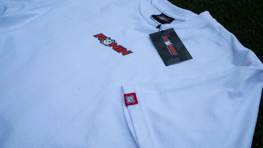 White shirt with a brand logo on a dark background