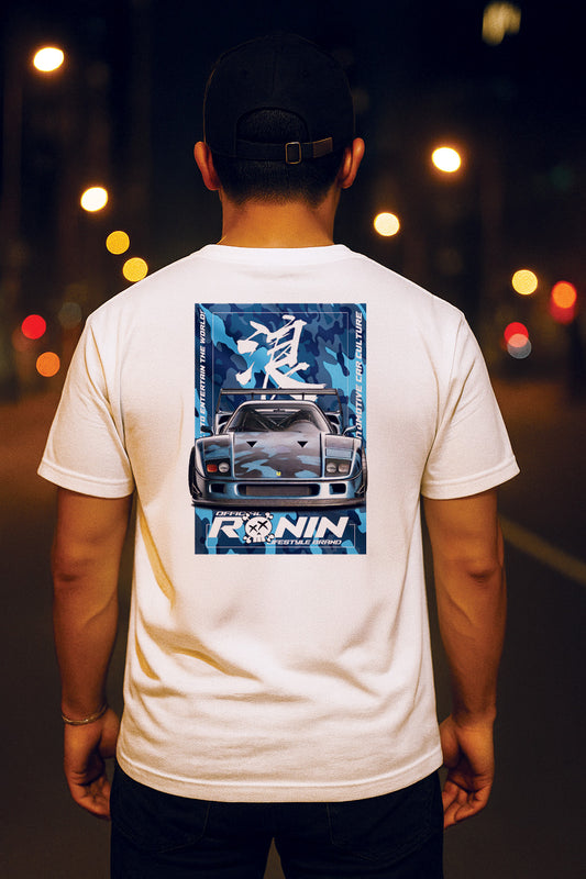 Person wearing a white t-shirt with a Ferrari F40 graphic and 'RONIN' text on the back, standing against a blurred street background.
