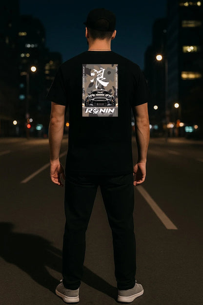 Person wearing a black t-shirt with 'Ronin' logo and a Nissan GTR design on the back, standing on a dark street.