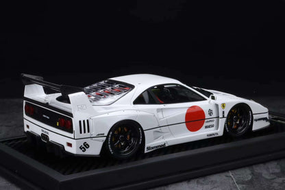 Model of a white sports car with racing decals on a dark background