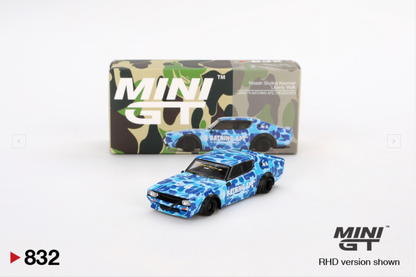 Blue camouflage die-cast car with packaging and 'MINI GT' branding on a white background.