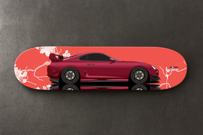Red Supra MK4 sports car design on a skateboard deck with a gray background